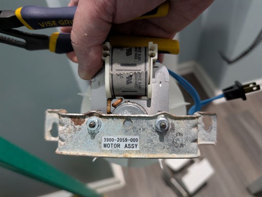 A bathroom exhaust fan with bracket and blower wheel attached
